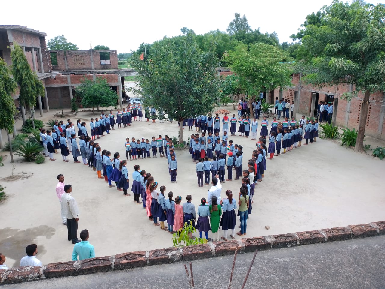Students forming a shape with the tricolour flag