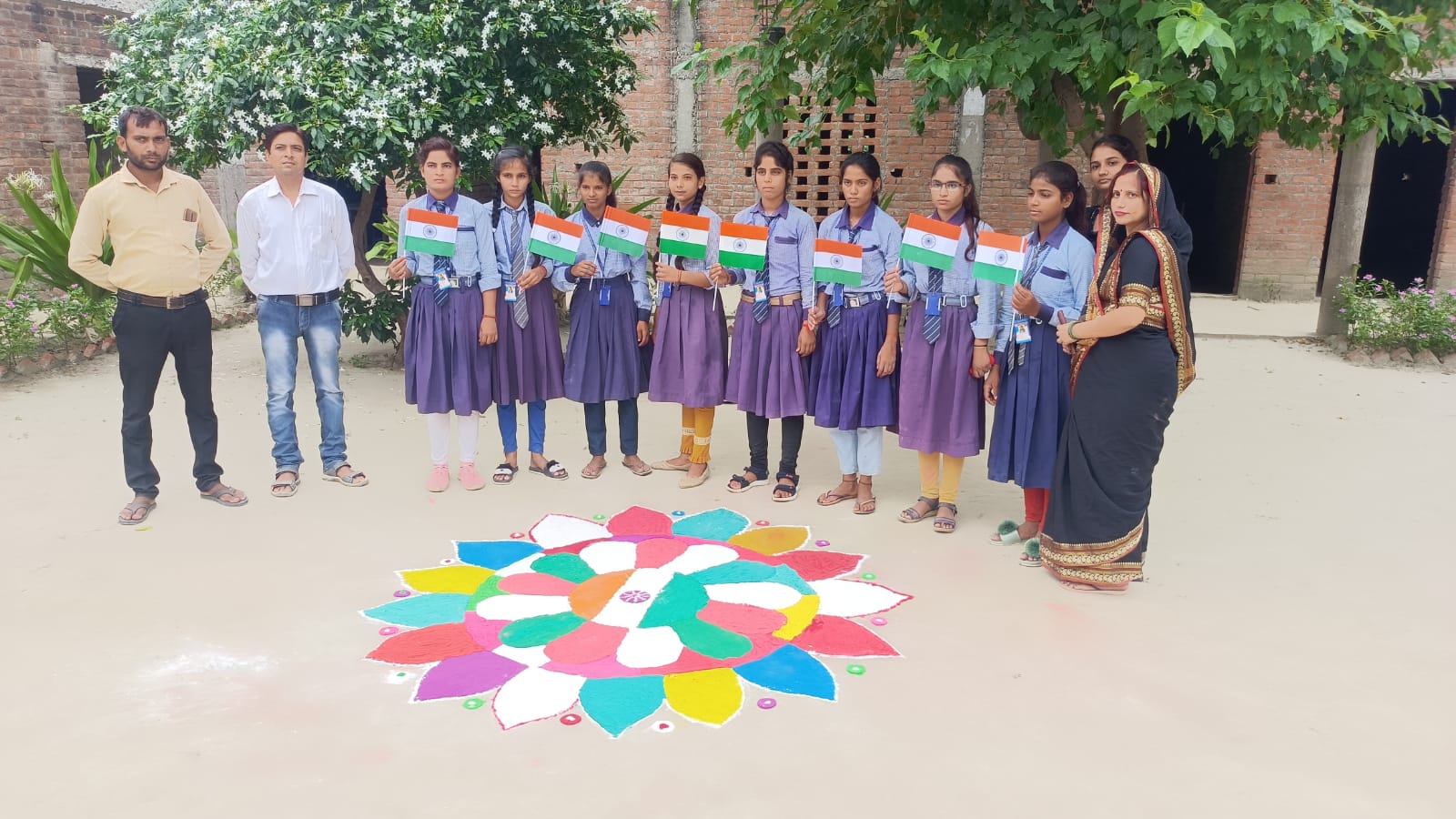 Students with a rangoli they made for Independence Day